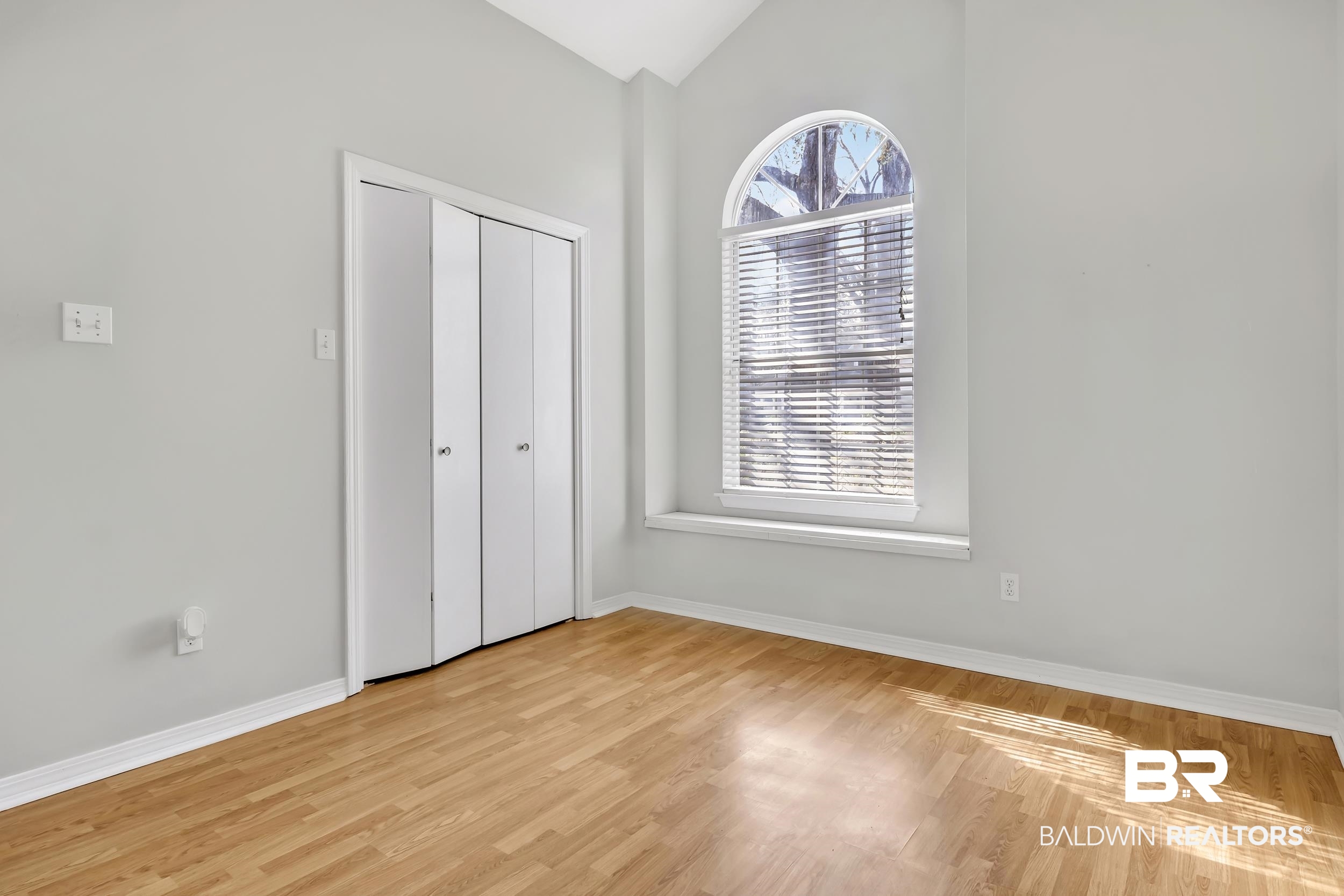6616 Conde Court Mobile, AL 36695 - Photo 23 of 27 Unfurnished bedroom featuring a closet, baseboards, lofted ceiling, and light wood finished floors