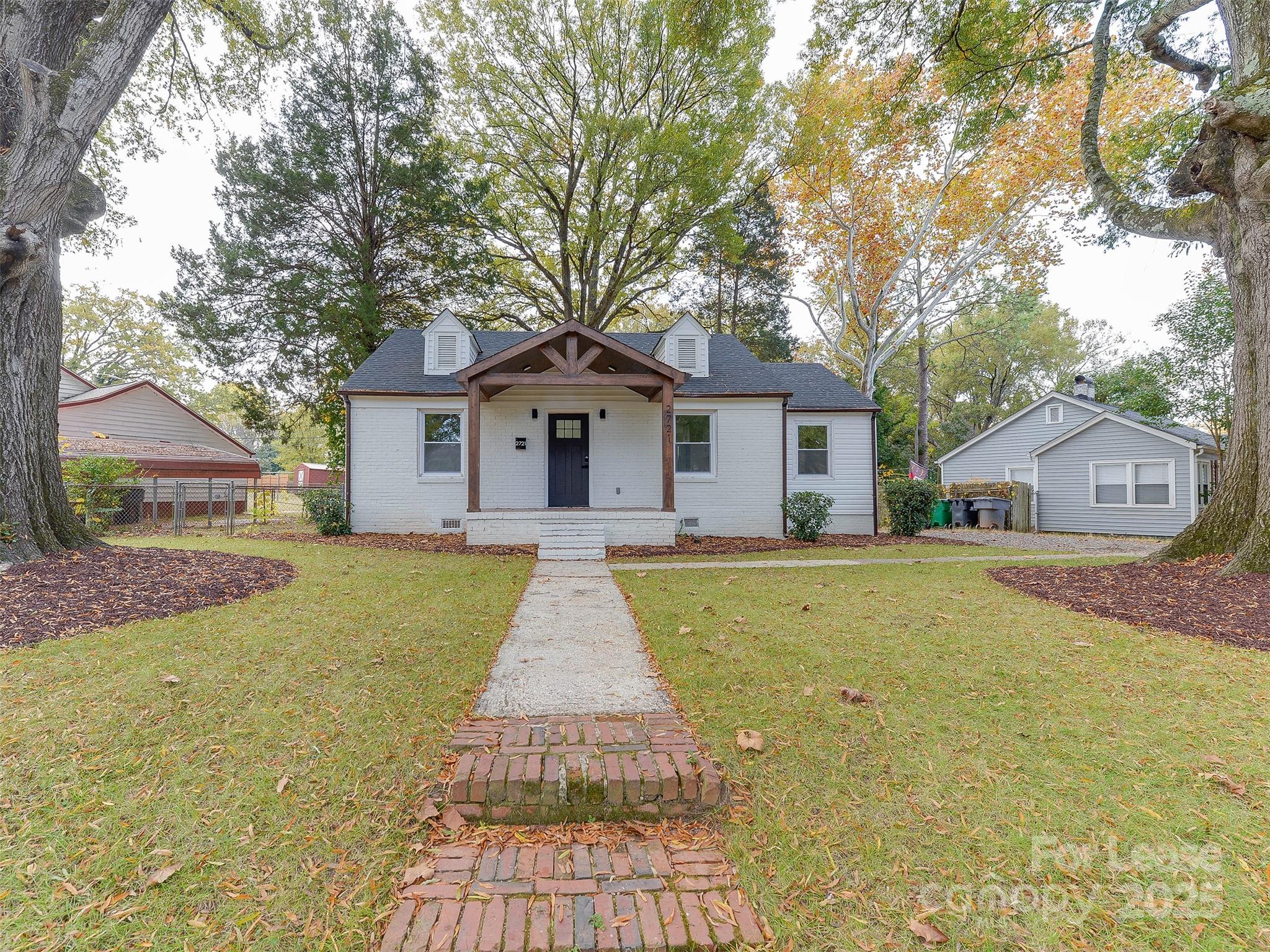 a front view of house with yard and green space