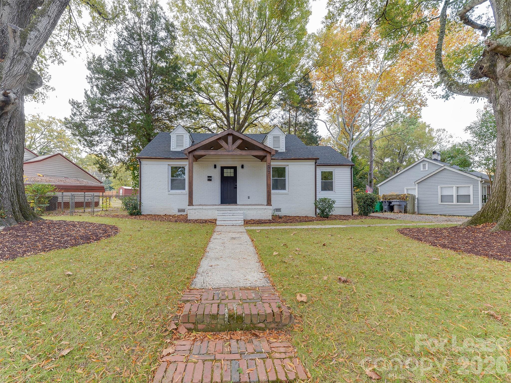 a front view of house with yard and green space
