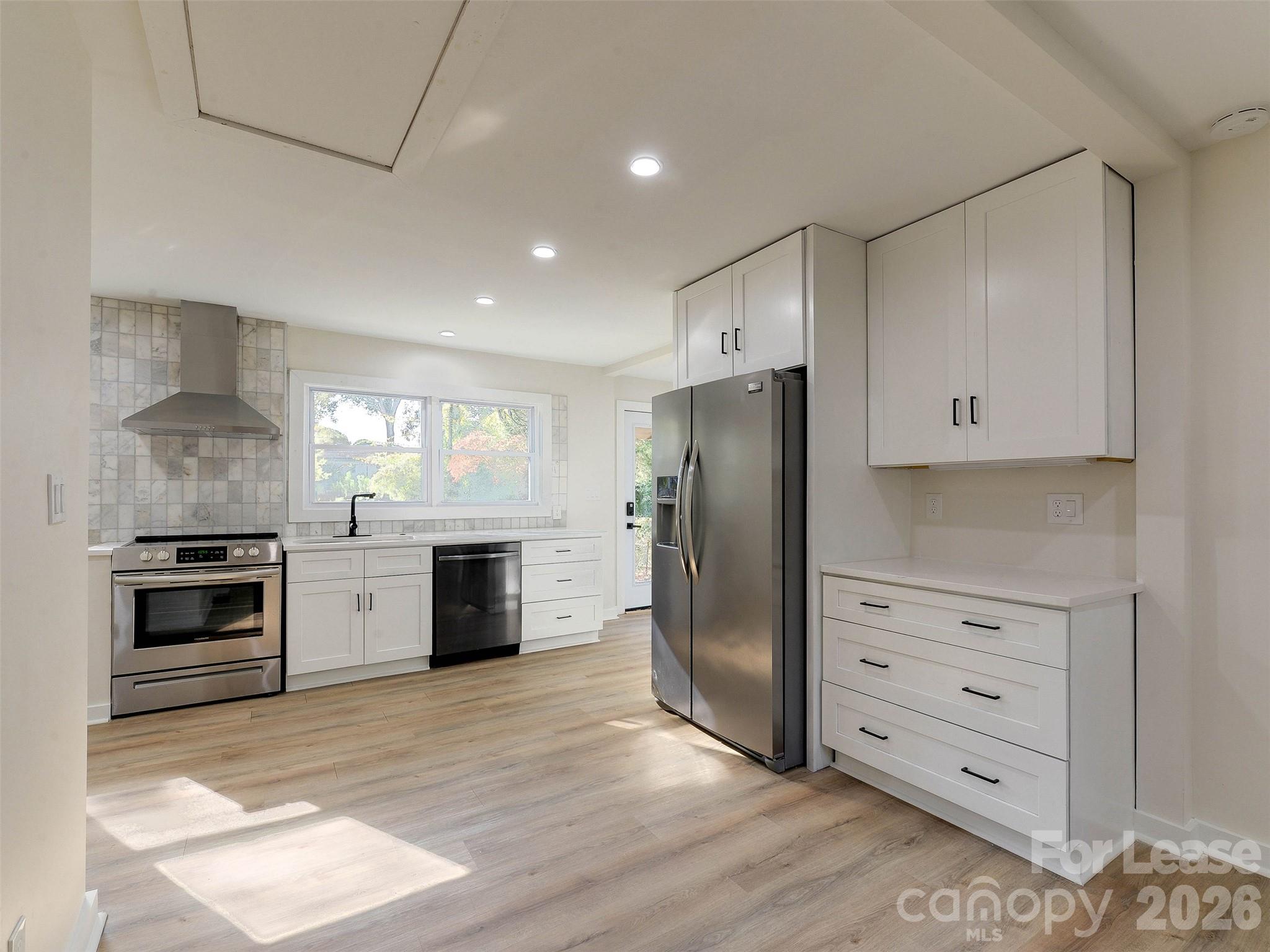 2721 Mayflower Road Charlotte, NC 28208 - Photo 12 of 42 a kitchen with granite countertop cabinets and steel stainless steel appliances