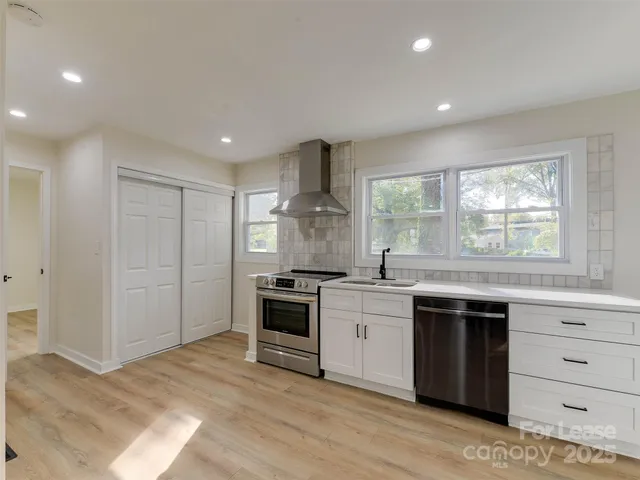 a kitchen with stainless steel appliances granite countertop a stove and a sink