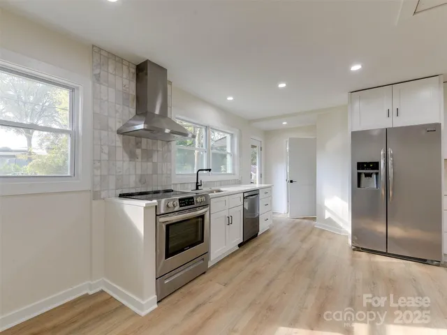 a kitchen with a stove a sink and a refrigerator