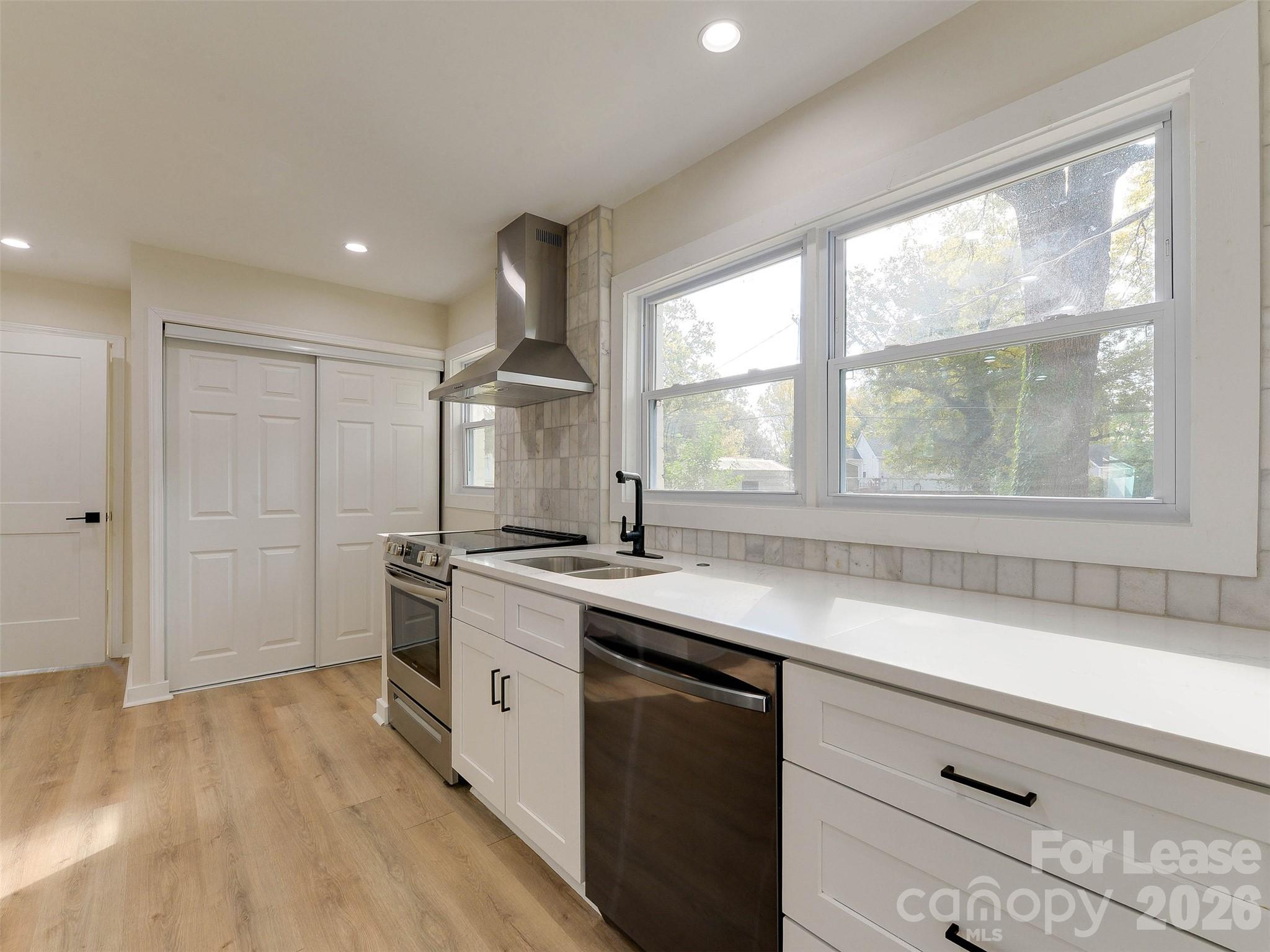 2721 Mayflower Road Charlotte, NC 28208 - Photo 17 of 42 a kitchen with a sink stove and cabinets