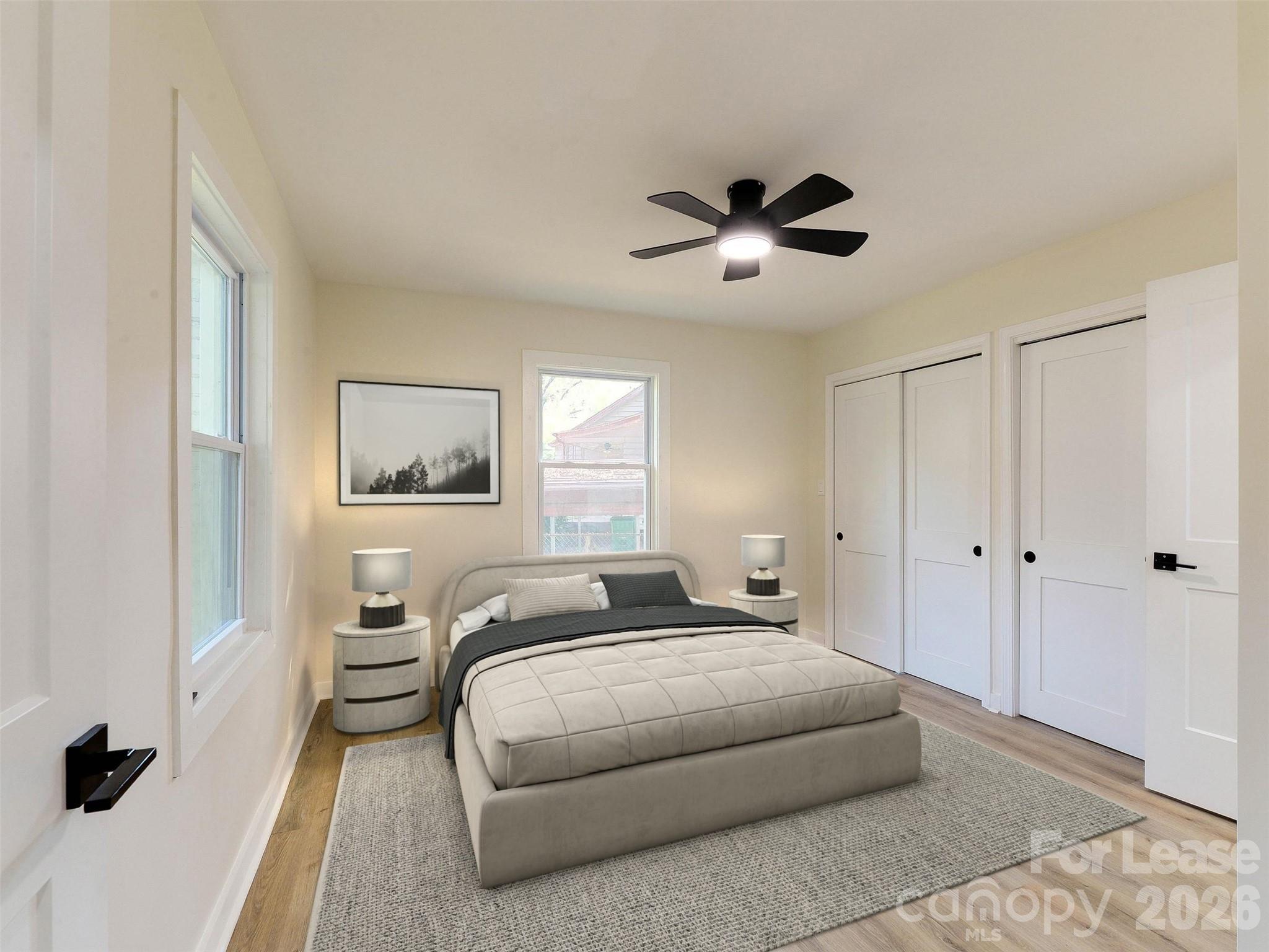 2721 Mayflower Road Charlotte, NC 28208 - Photo 21 of 42 a bedroom with a large bed and a chandelier