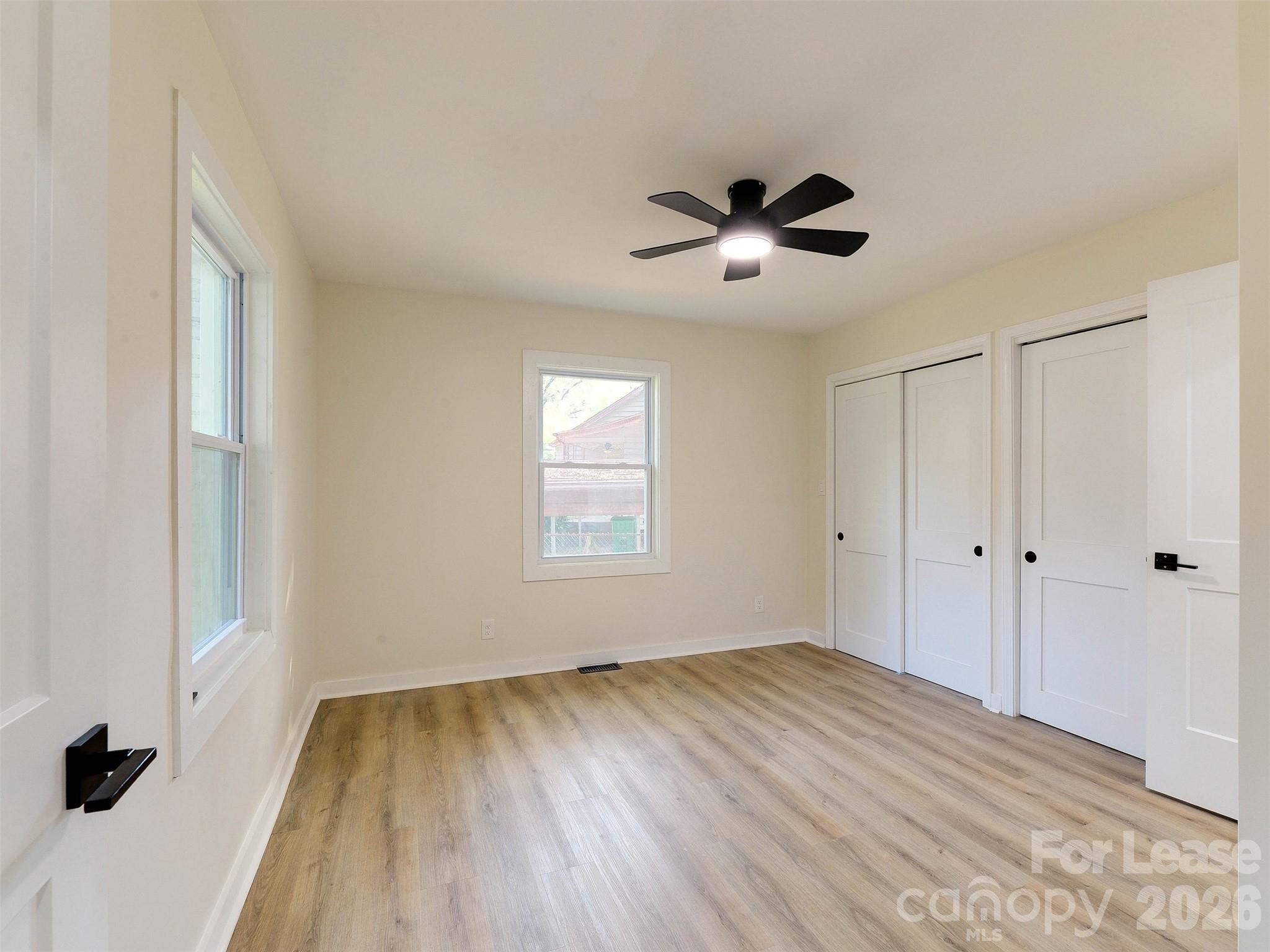2721 Mayflower Road Charlotte, NC 28208 - Photo 22 of 42 a view of empty room with wooden floor and fan