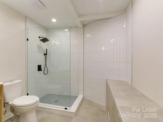 a bathroom with a shower and a toilet