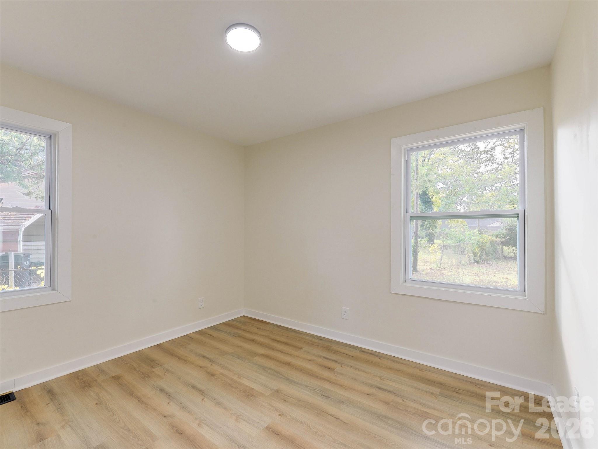 2721 Mayflower Road Charlotte, NC 28208 - Photo 27 of 42 an empty room with wooden floor and windows