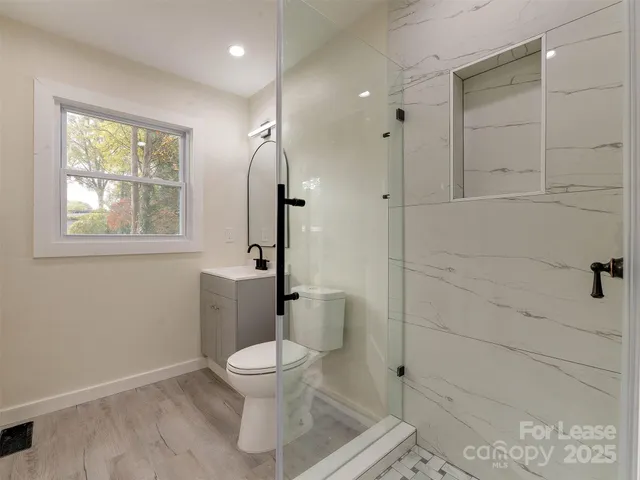 a bathroom with a toilet sink and shower