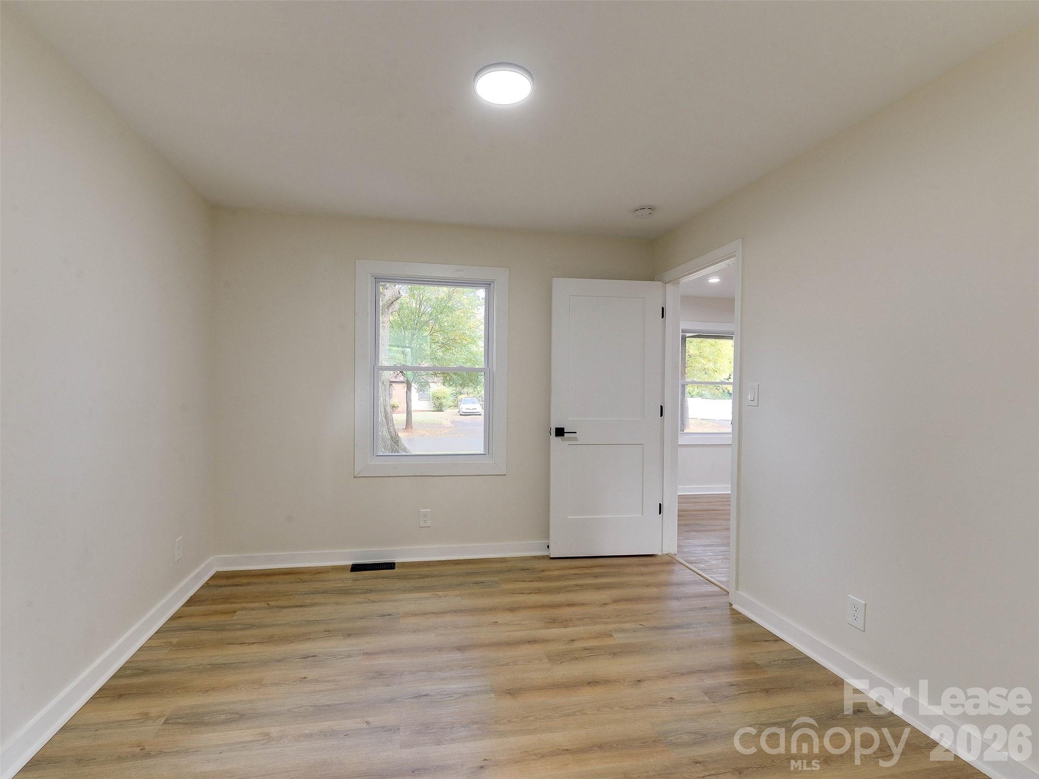 2721 Mayflower Road Charlotte, NC 28208 - Photo 30 of 42 an empty room with wooden floor and windows