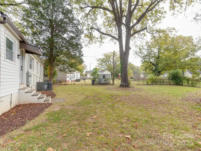 a view of a yard with a tree