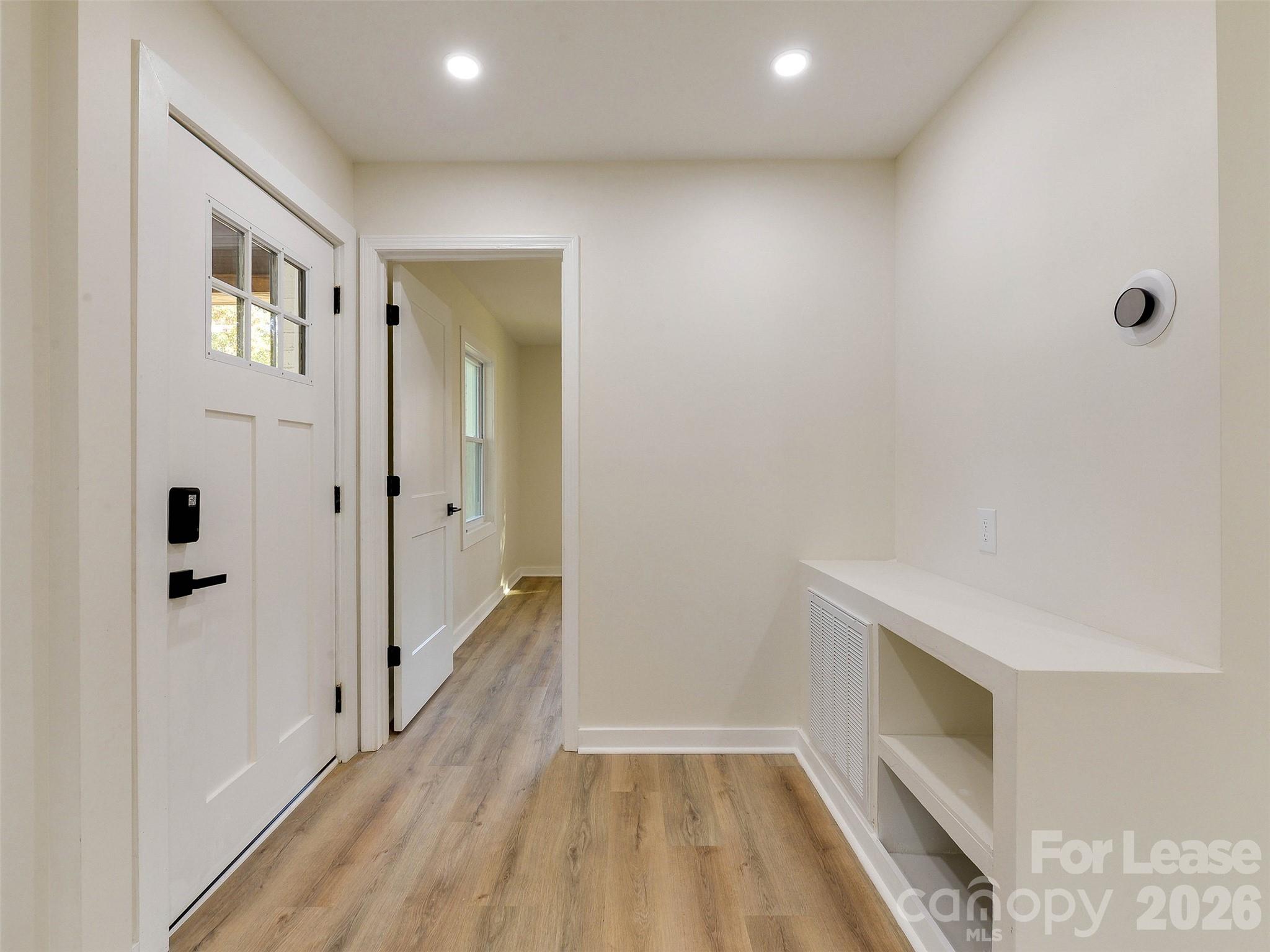 2721 Mayflower Road Charlotte, NC 28208 - Photo 6 of 42 a view of a hallway with wooden floor and staircase