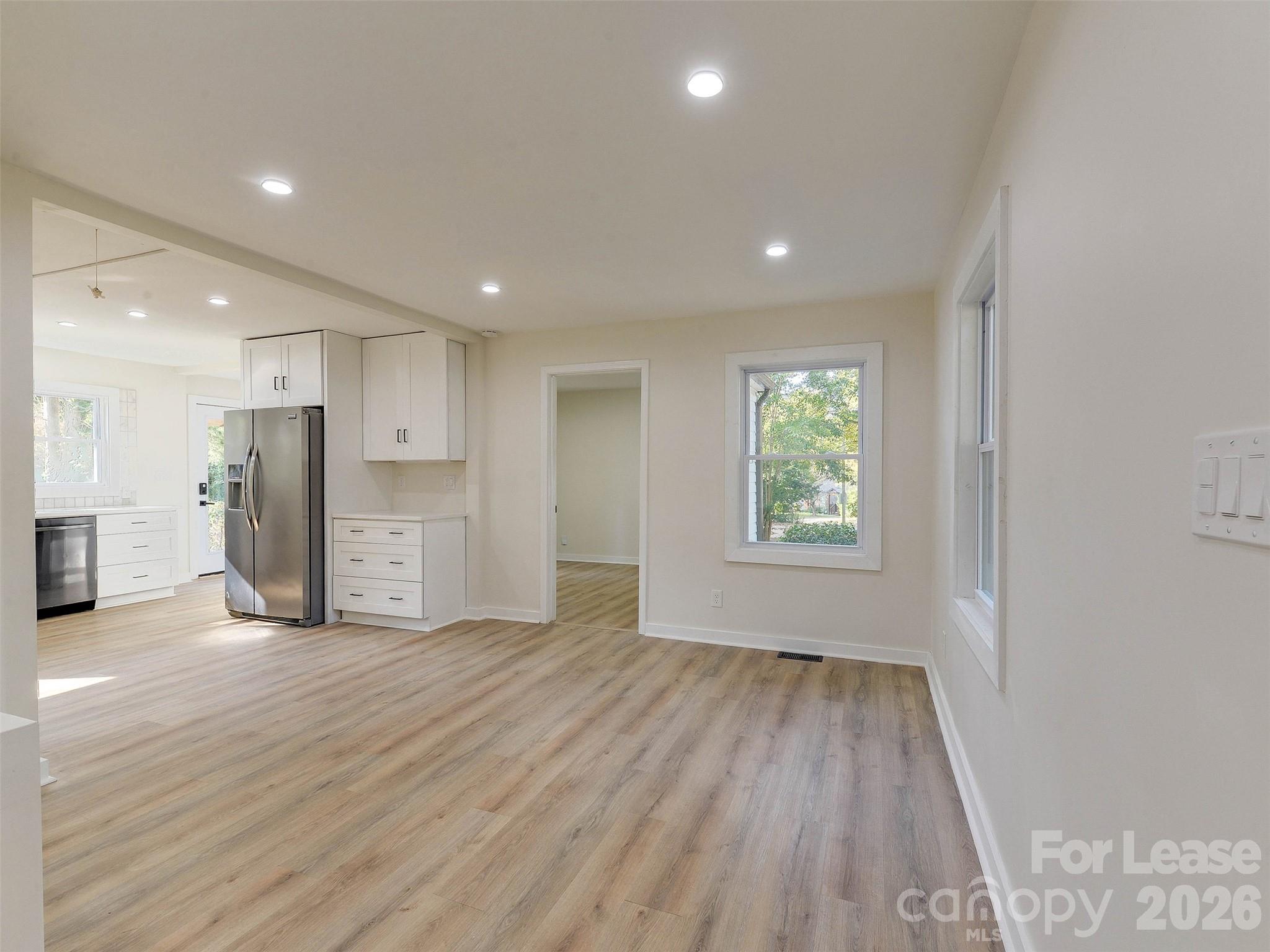 2721 Mayflower Road Charlotte, NC 28208 - Photo 8 of 42 a view of empty room with wooden floor and window