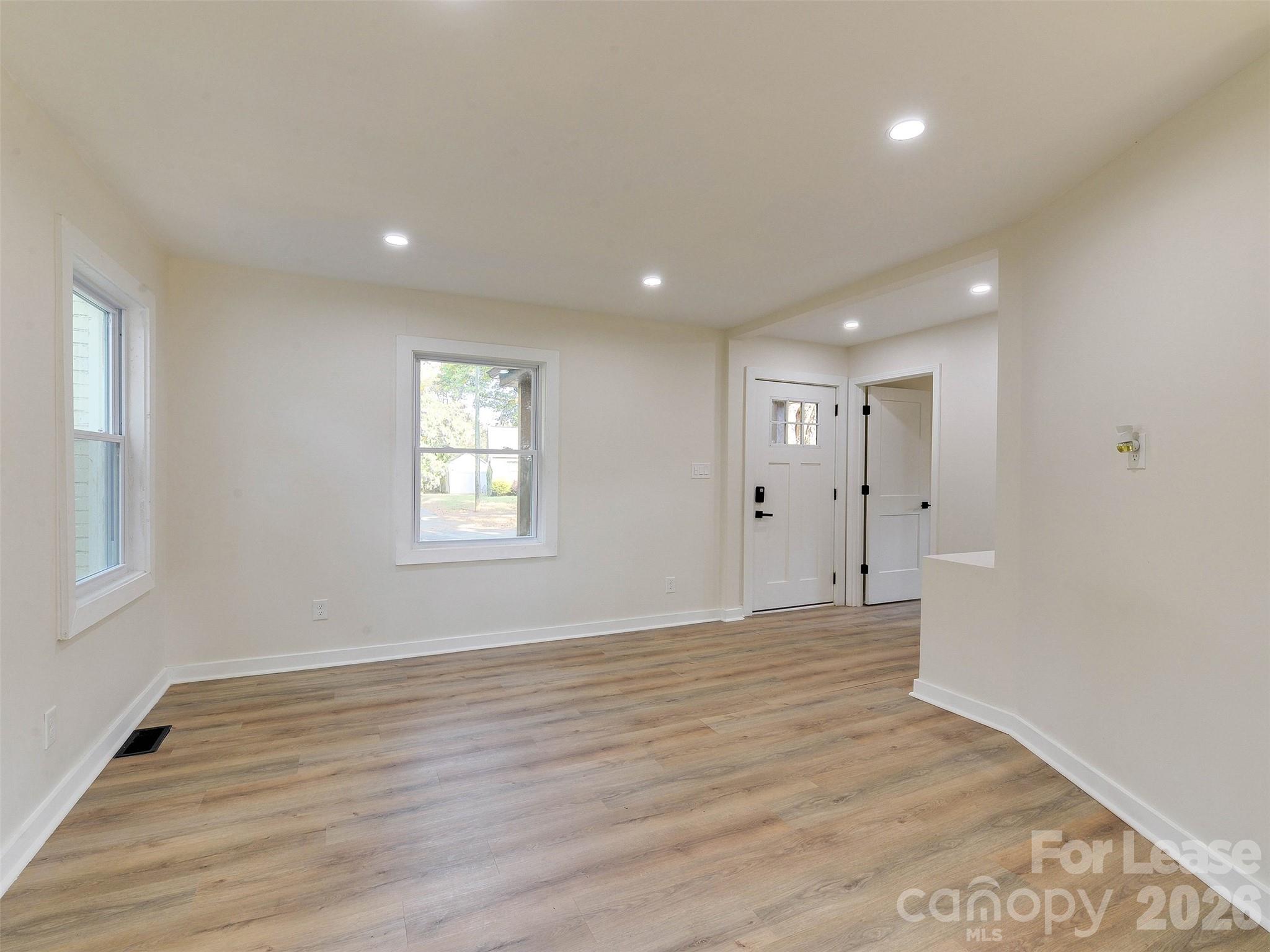 2721 Mayflower Road Charlotte, NC 28208 - Photo 10 of 42 a view of an empty room with wooden floor and a window