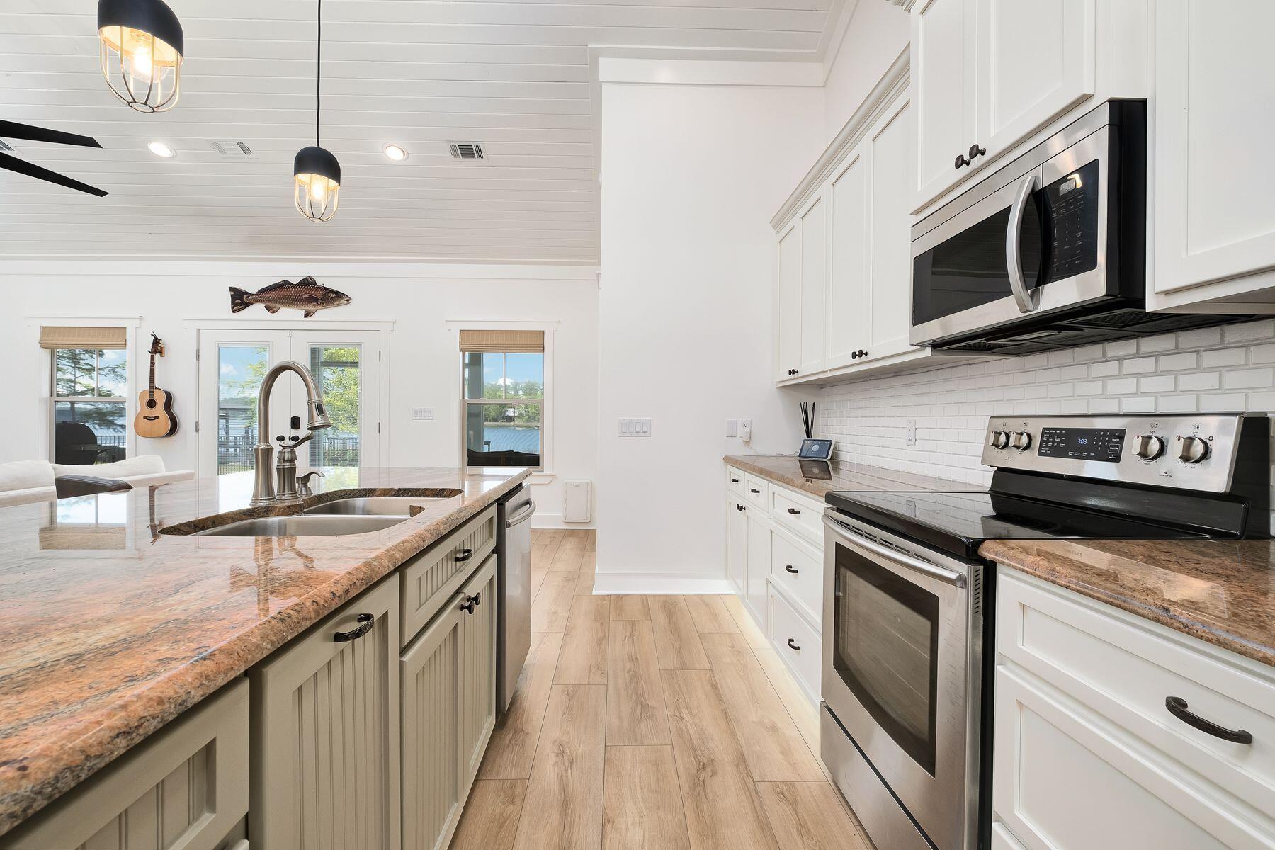 716 Bay Grove Road Freeport, FL 32439 - Photo 9 of 46 a kitchen with stainless steel appliances granite countertop a stove and a microwave