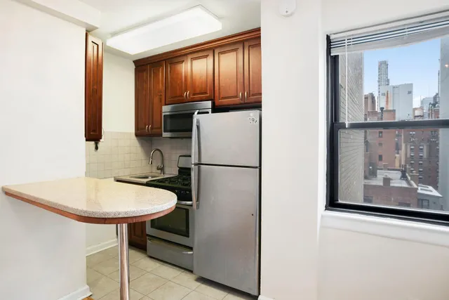 a view of a bedroom with wooden floor and windows