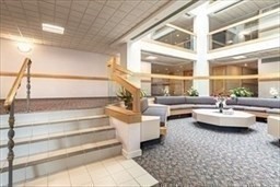 166 Place Lane, Unit 166 Woburn, MA 01801 - Photo 23 of 26 a living room with fireplace furniture and floor to ceiling windows