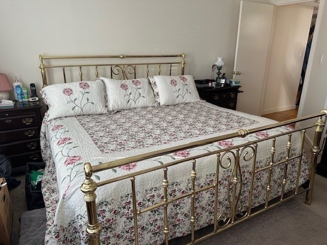 166 Place Lane, Unit 166 Woburn, MA 01801 - Photo 10 of 26 a bed sitting in a bedroom next to a window with wooden floor