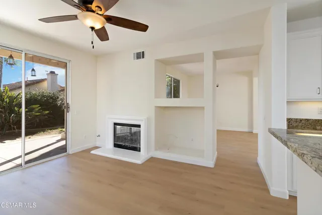 a view of a kitchen an empty room and window