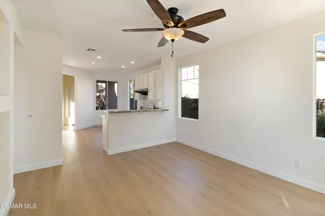a view of a kitchen with a sink and a ceiling fan