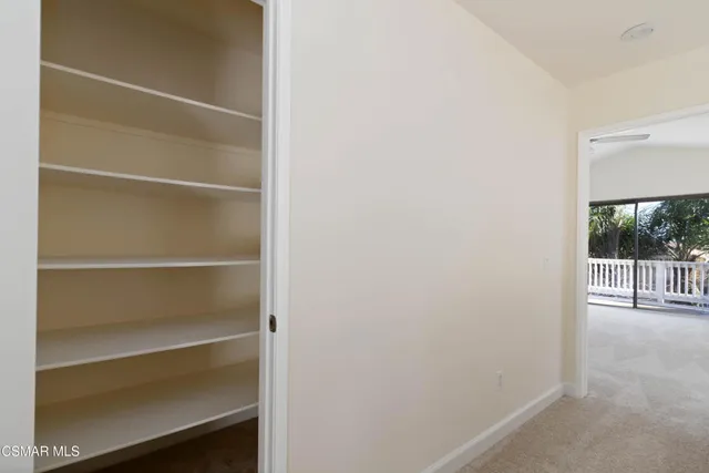 a view of a room with stairs and a ceiling fan
