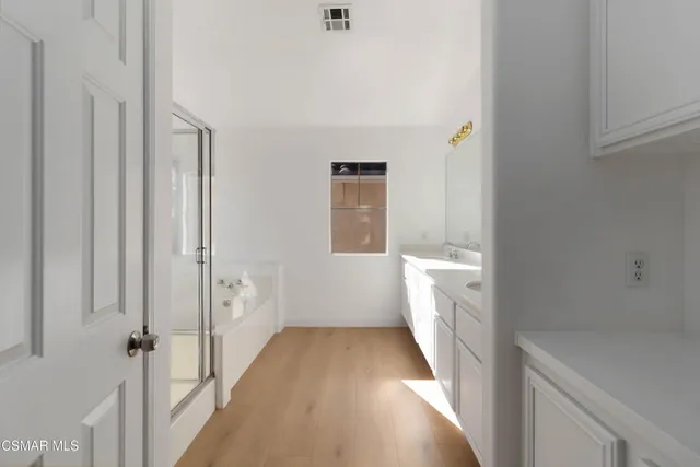 a bathroom with a bathtub and a shower
