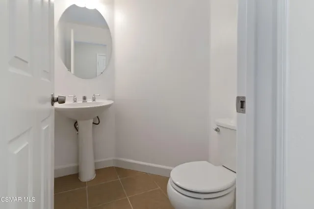 a bathroom with a sink toilet and a mirror