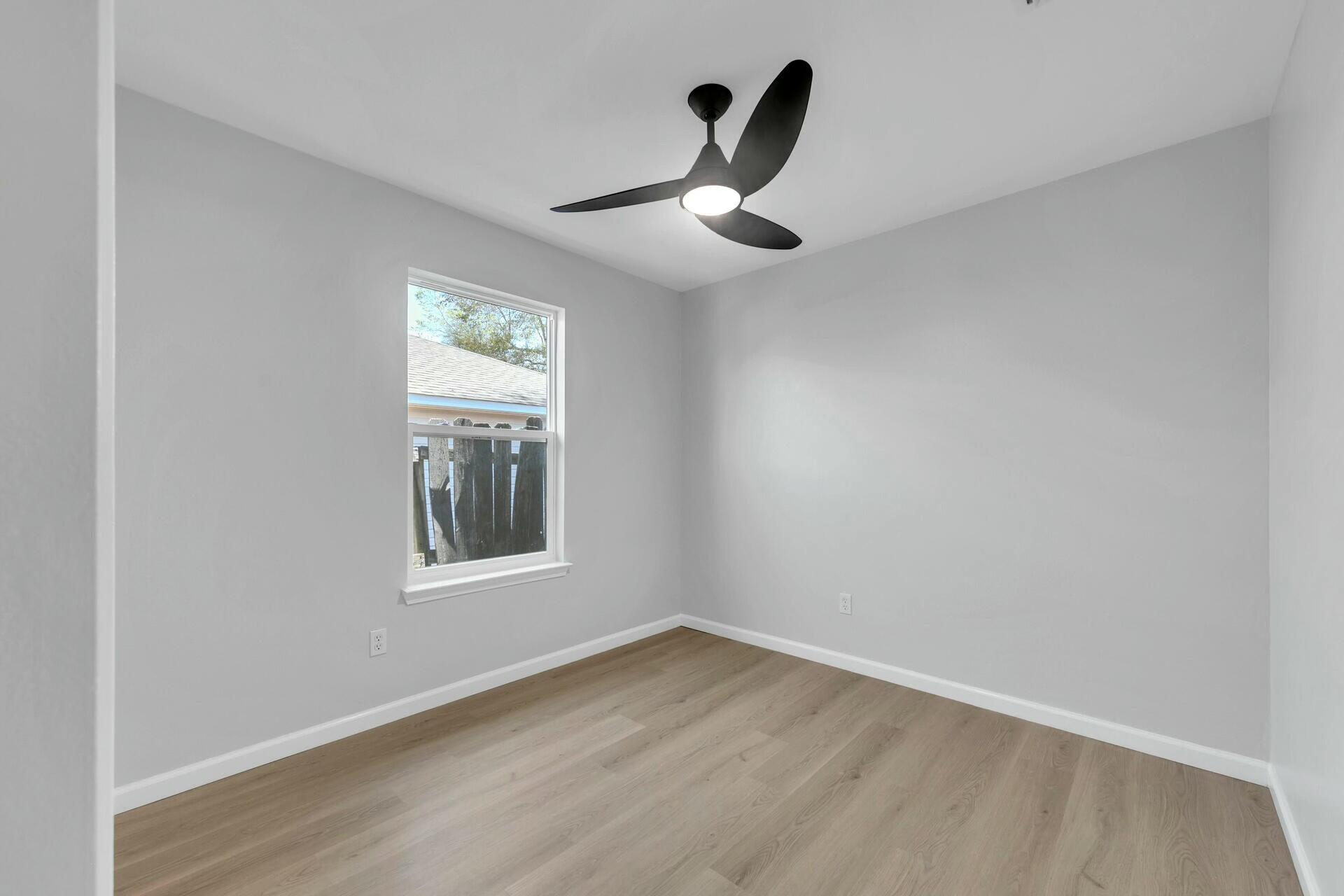 330 Apple Drive Crestview, FL 32536 - Photo 15 of 29 an empty room with a window and a ceiling fan