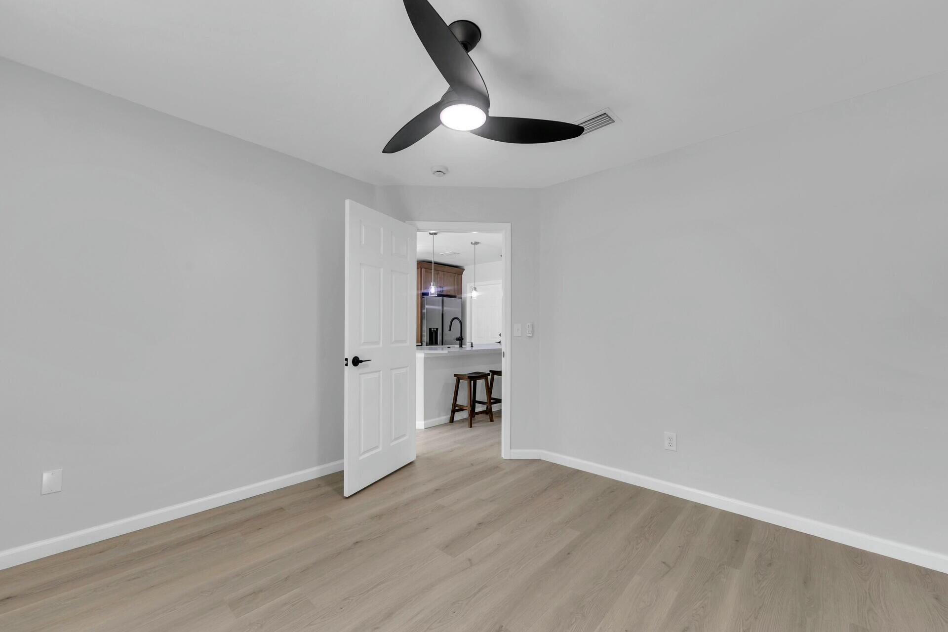 330 Apple Drive Crestview, FL 32536 - Photo 17 of 29 a view of empty room with wooden floor and ceiling fan