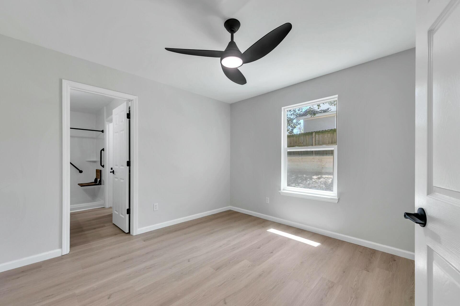 330 Apple Drive Crestview, FL 32536 - Photo 19 of 29 wooden floor in an empty room with a window