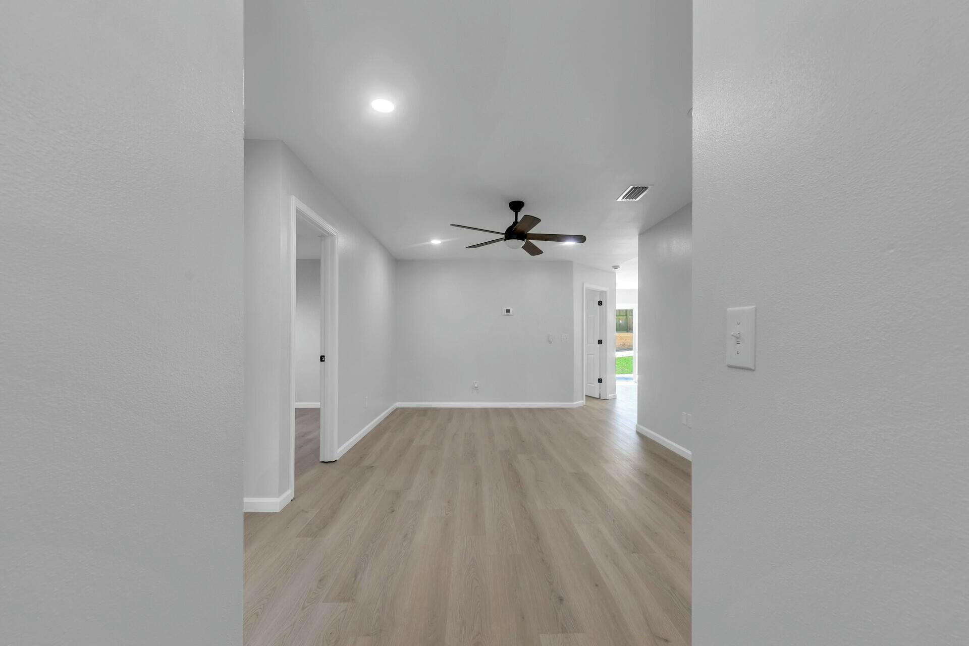 330 Apple Drive Crestview, FL 32536 - Photo 23 of 29 wooden floor in an empty room with a window