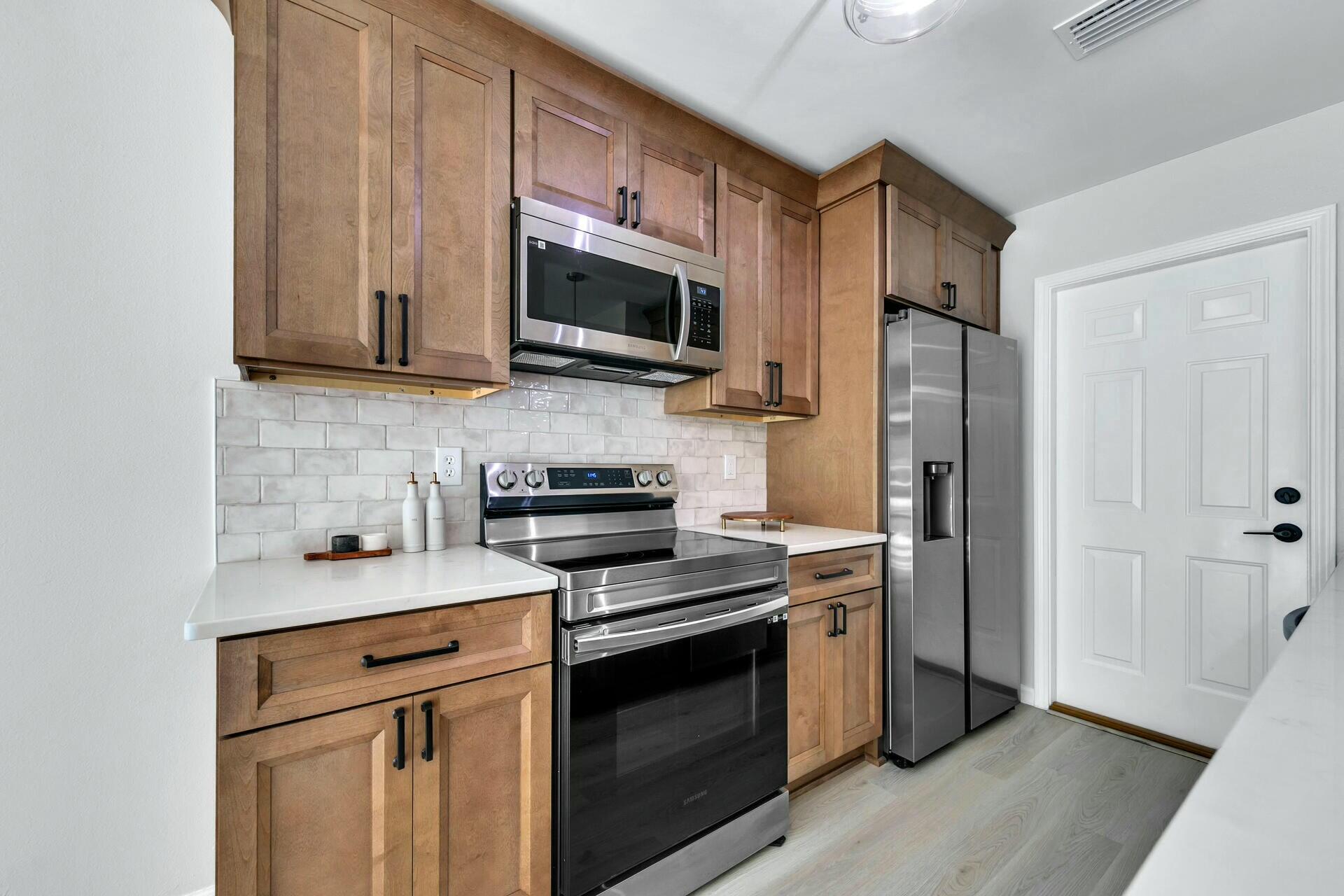 330 Apple Drive Crestview, FL 32536 - Photo 4 of 29 a kitchen with stainless steel appliances a stove microwave and sink