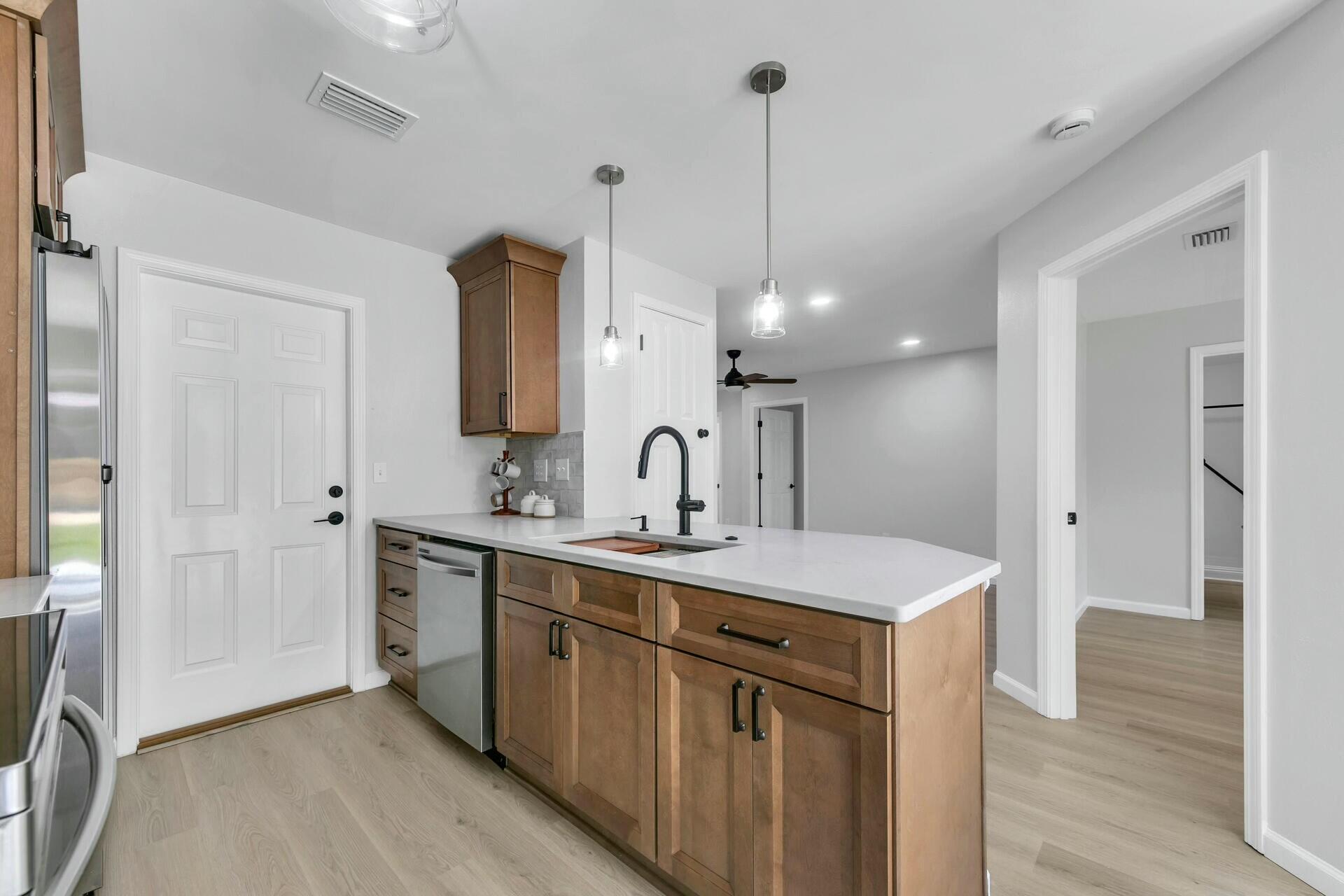 330 Apple Drive Crestview, FL 32536 - Photo 5 of 29 a view of a sink and a refrigerator a mirror