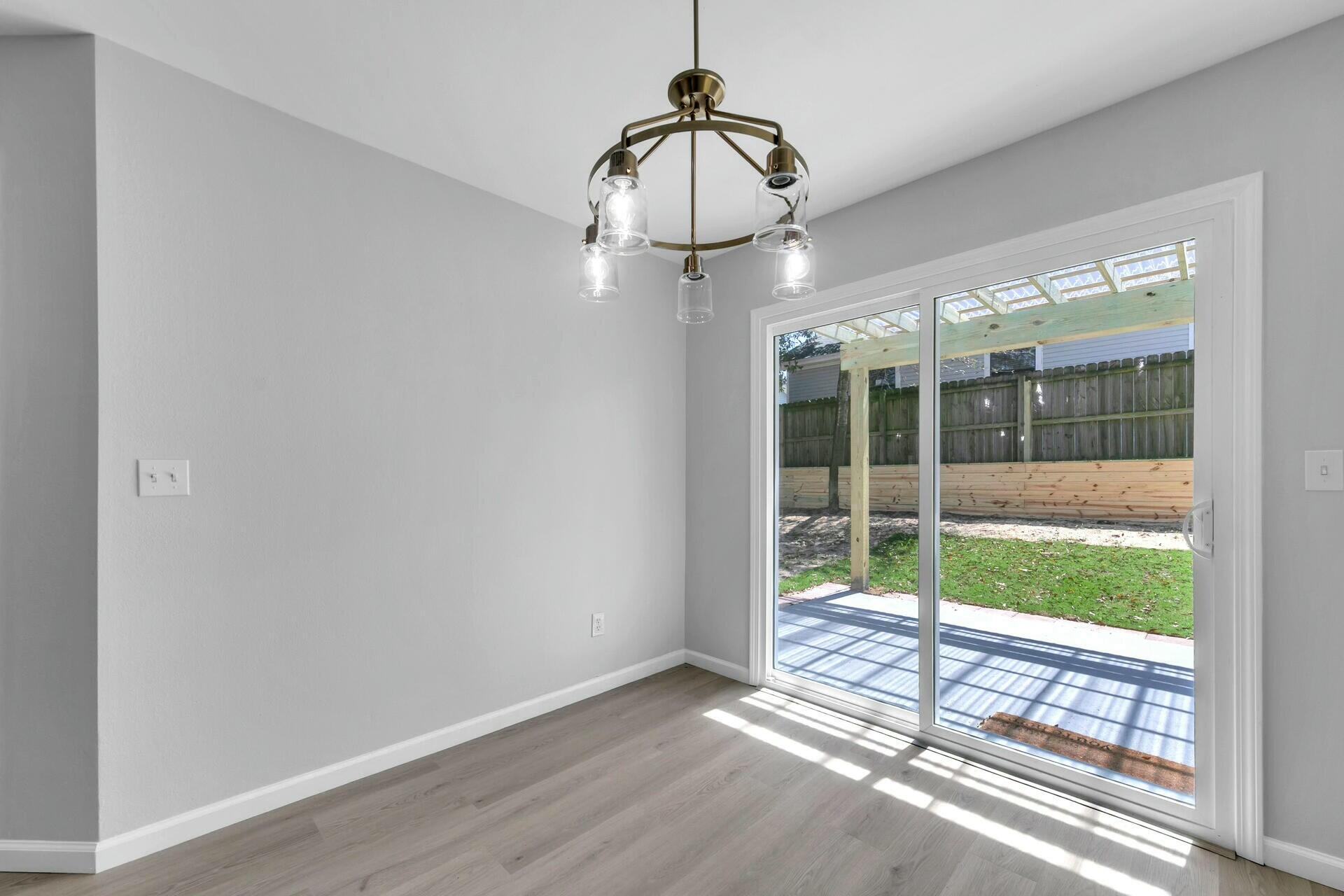 330 Apple Drive Crestview, FL 32536 - Photo 9 of 29 a view of a room that has a large window and wooden floor