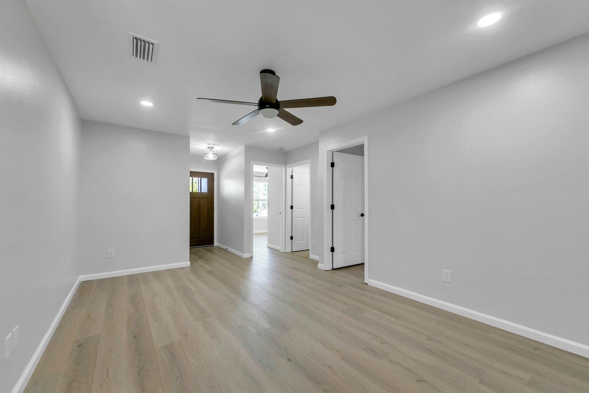 330 Apple Drive Crestview, FL 32536 - Photo 10 of 29 a view of an empty room and wooden floor