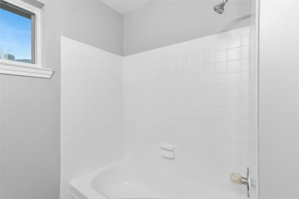 a bathroom with a white bath tub