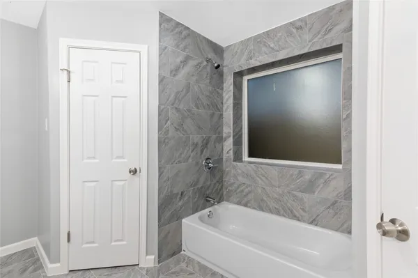 a bathroom with a bathtub and shower
