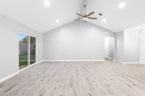 a view of an empty room with glass door