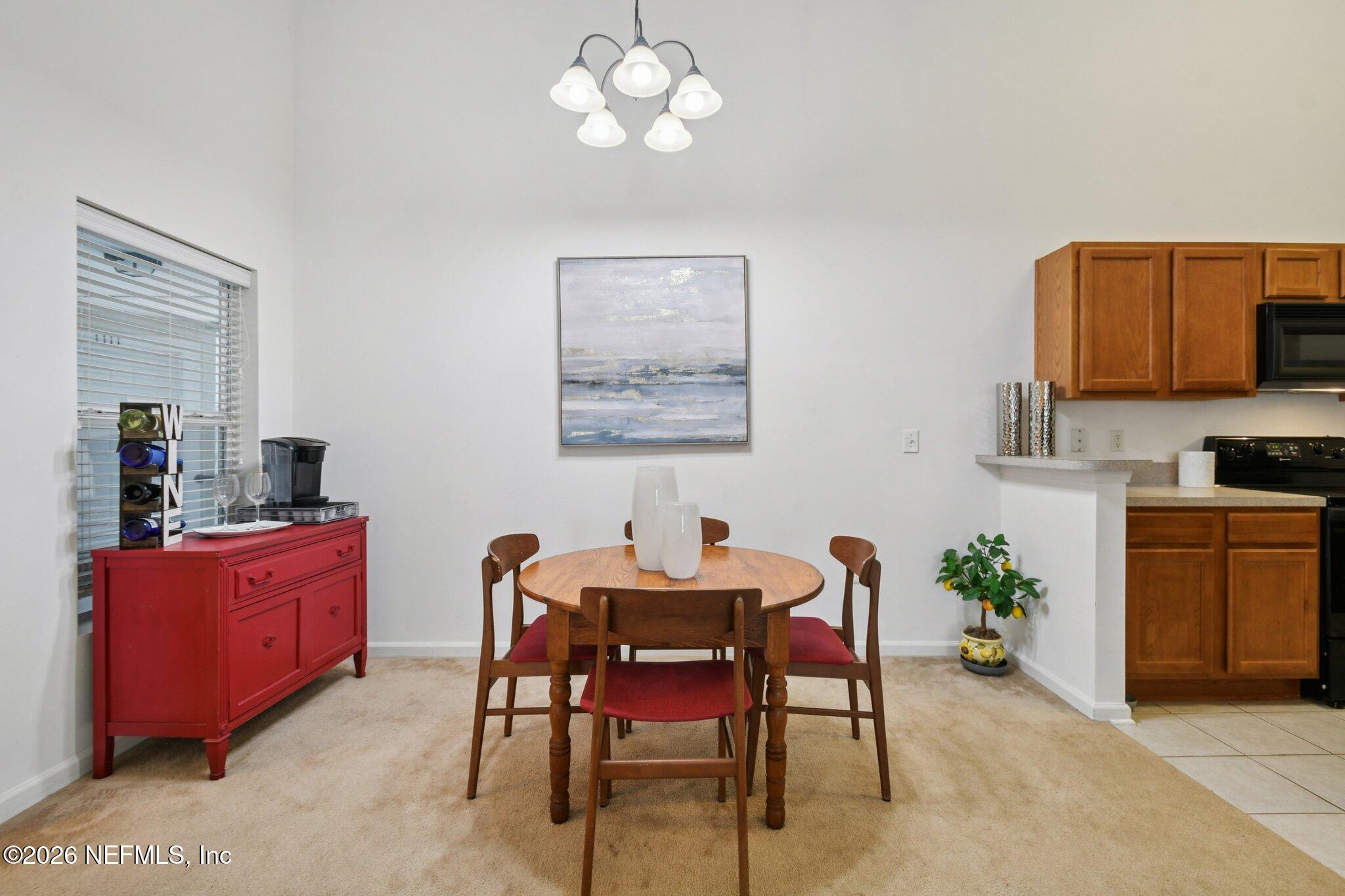 7920 Merrill Road, Unit 1114 Jacksonville, FL 32277 - Photo 12 of 31 a dining room with furniture and window