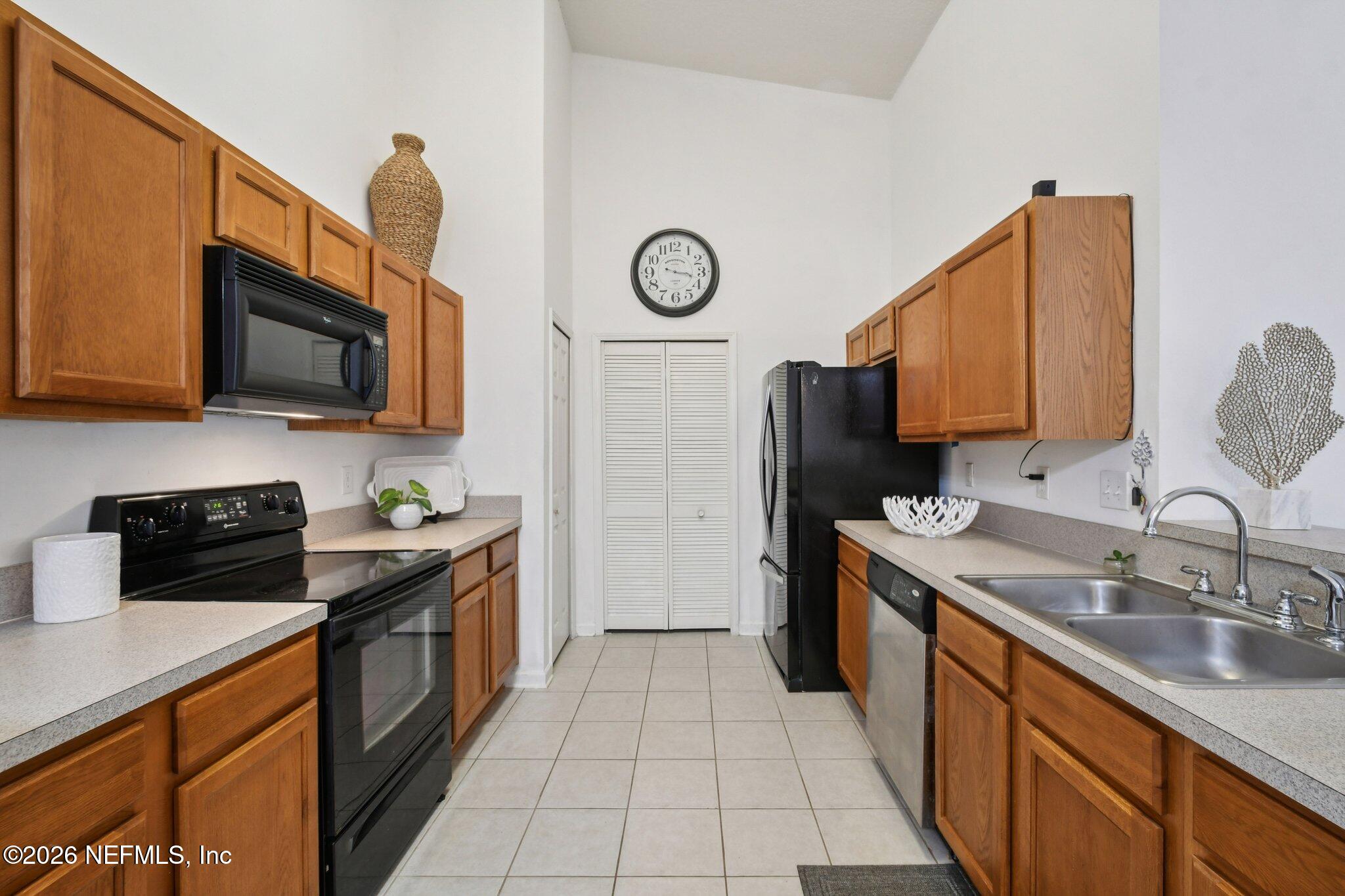 7920 Merrill Road, Unit 1114 Jacksonville, FL 32277 - Photo 14 of 31 a kitchen with stainless steel appliances granite countertop a sink stove and refrigerator