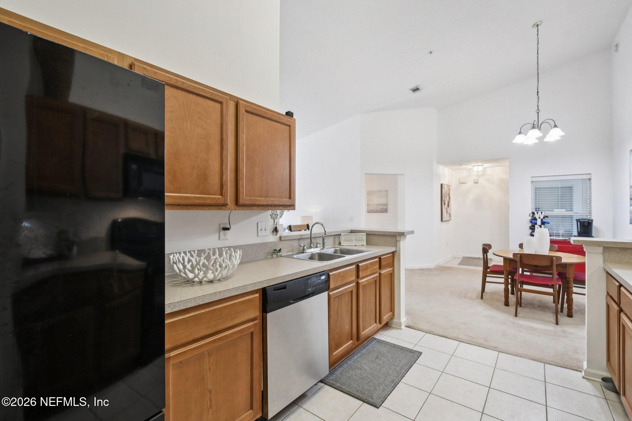 7920 Merrill Road, Unit 1114 Jacksonville, FL 32277 - Photo 16 of 31 a kitchen with a sink and cabinets