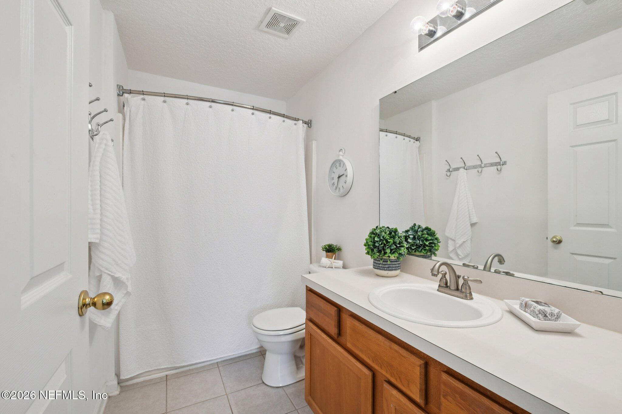 7920 Merrill Road, Unit 1114 Jacksonville, FL 32277 - Photo 21 of 31 a bathroom with a sink toilet and shower