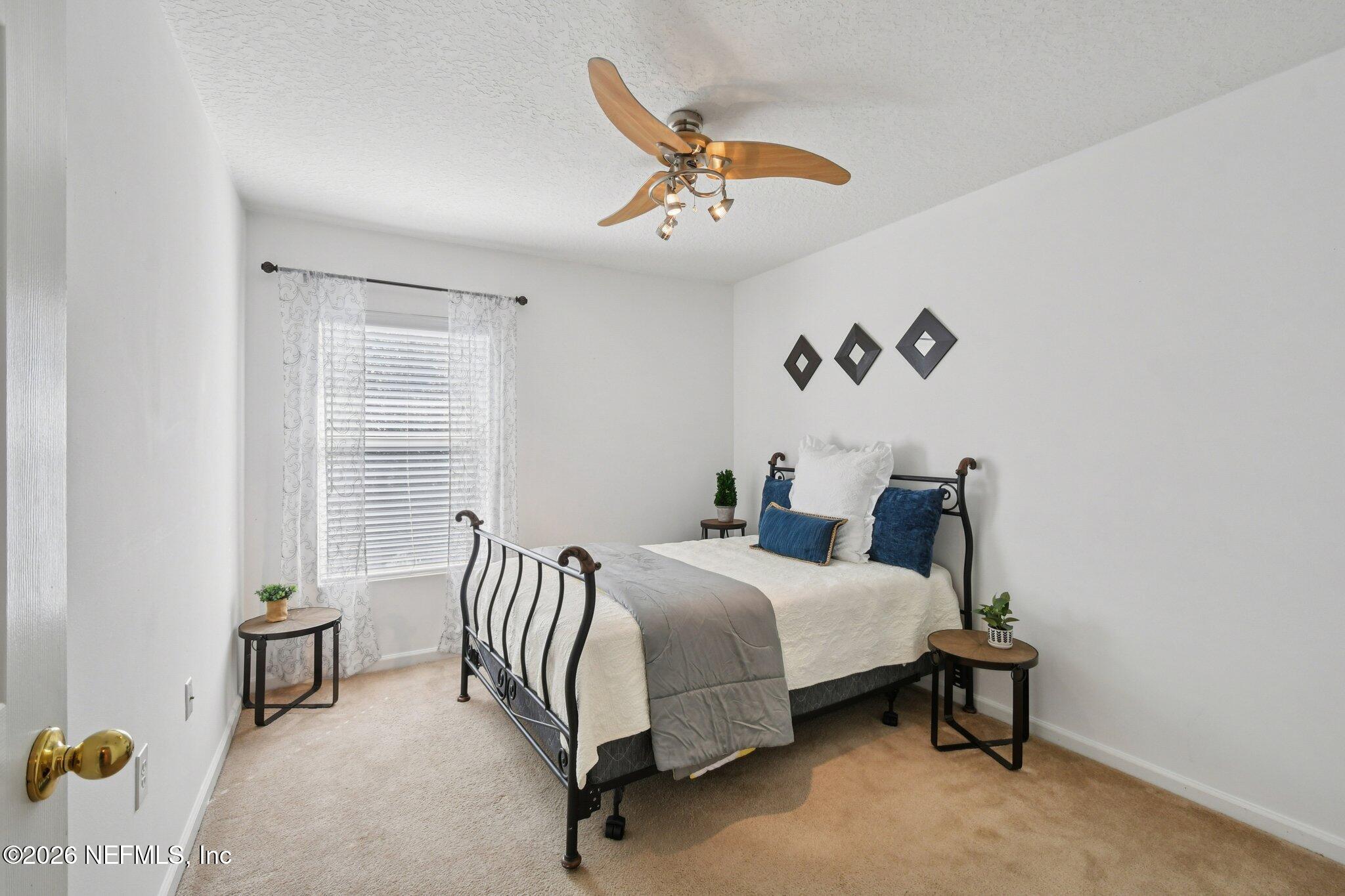 7920 Merrill Road, Unit 1114 Jacksonville, FL 32277 - Photo 23 of 31 a bedroom with a bed and a window