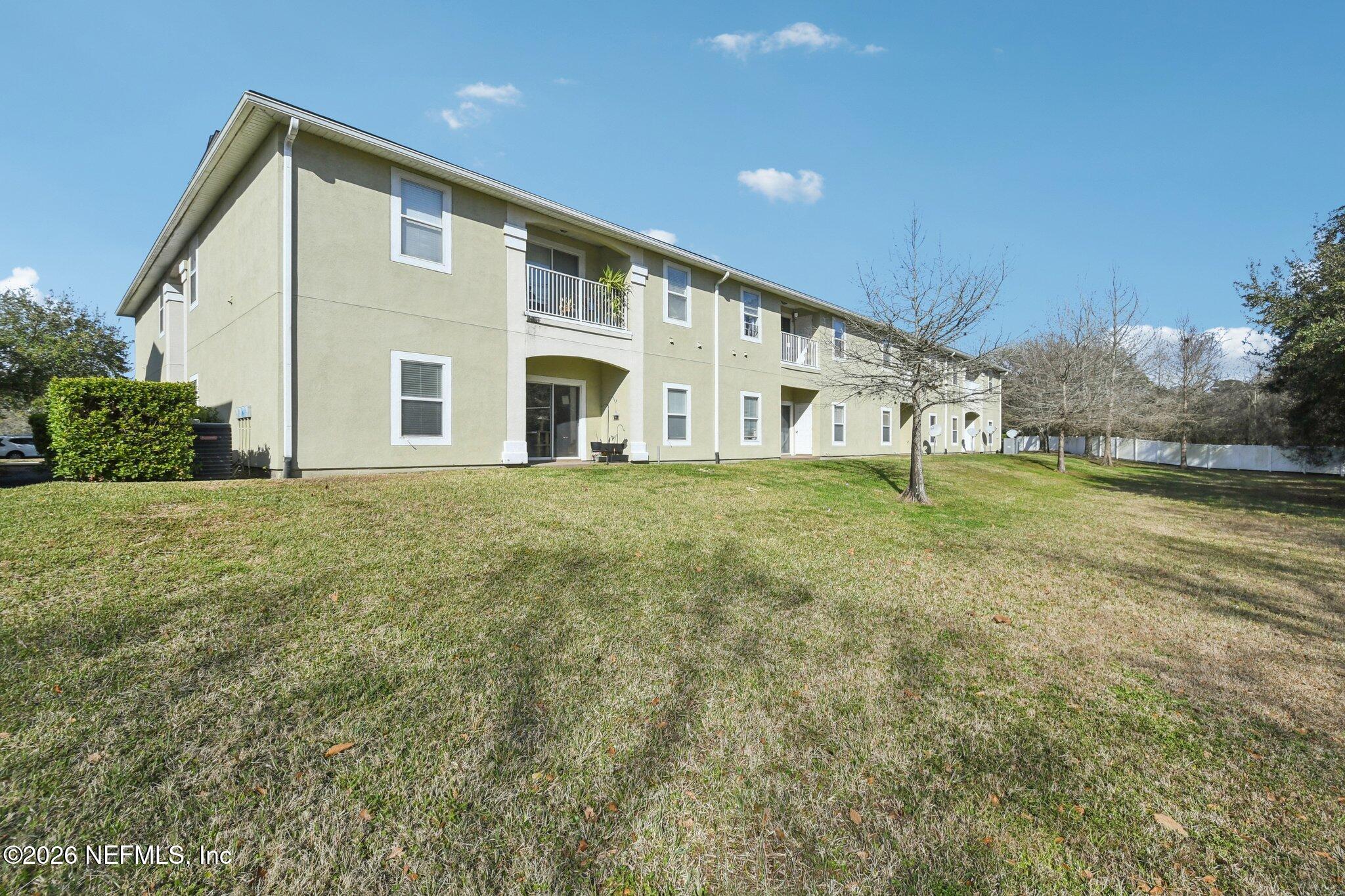 7920 Merrill Road, Unit 1114 Jacksonville, FL 32277 - Photo 25 of 31 a front view of a house with a yard
