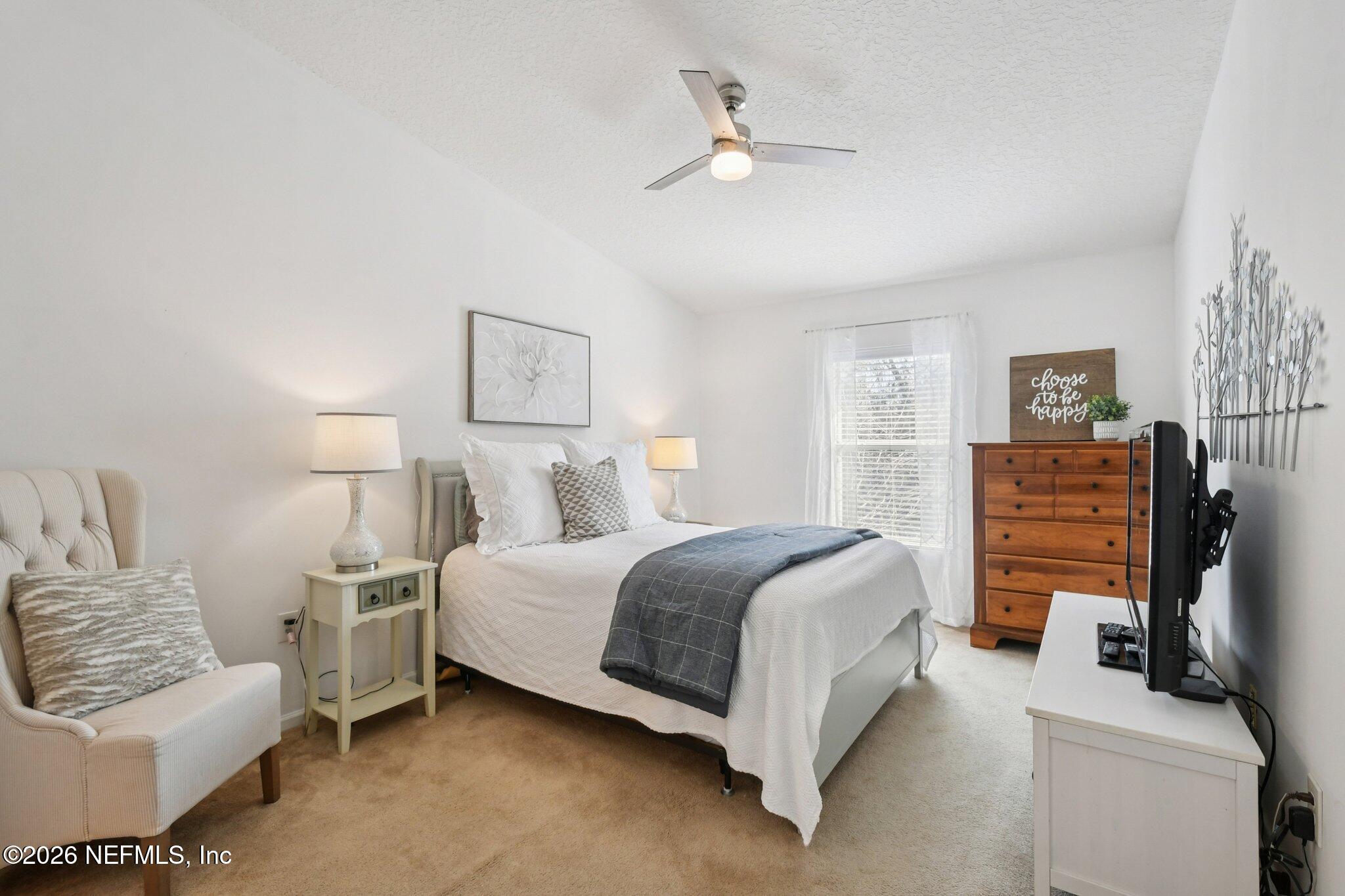 7920 Merrill Road, Unit 1114 Jacksonville, FL 32277 - Photo 4 of 31 a spacious bedroom with a bed and a couch
