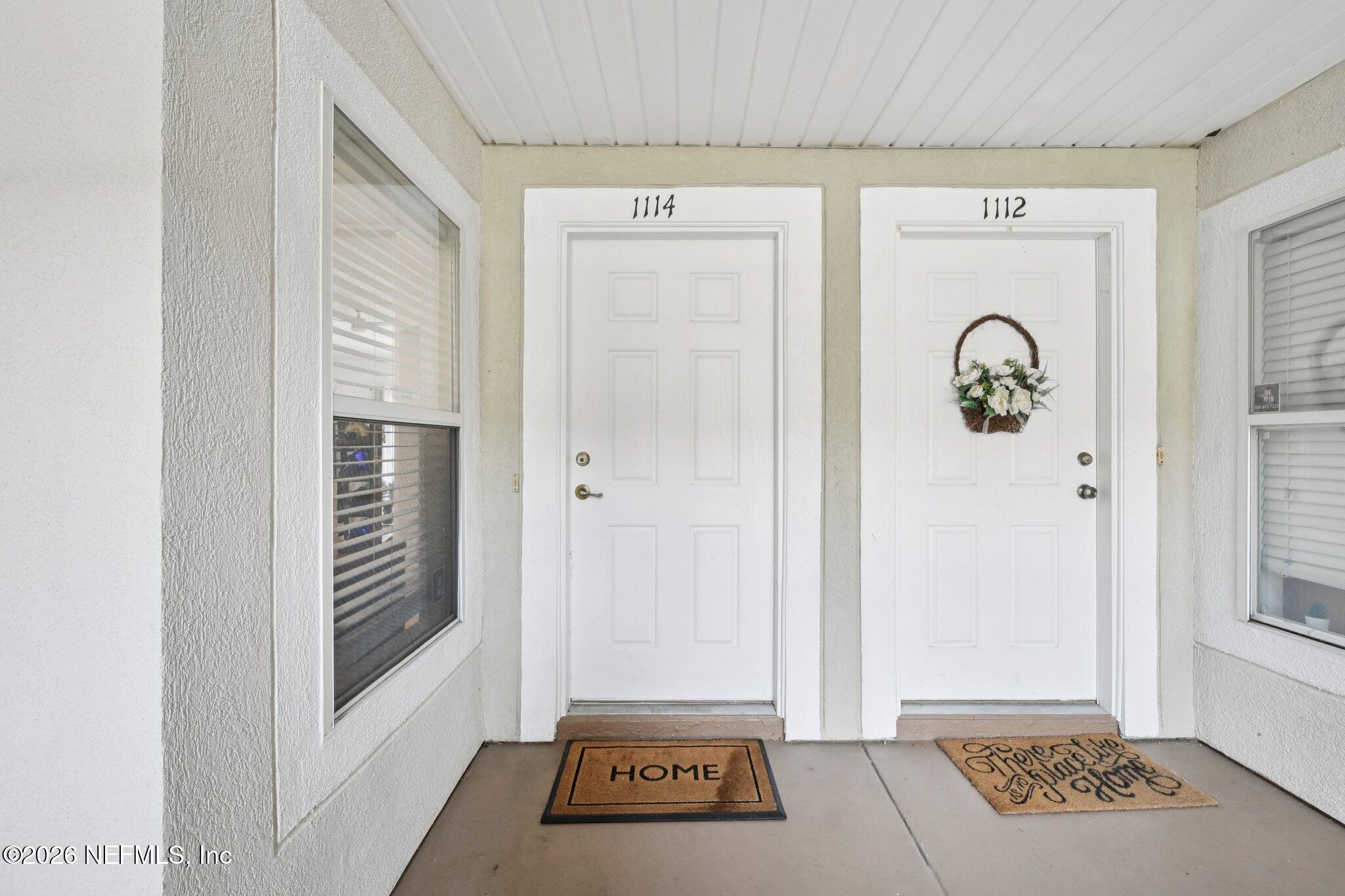 7920 Merrill Road, Unit 1114 Jacksonville, FL 32277 - Photo 8 of 31 a view of a hallway with wooden floor and windows