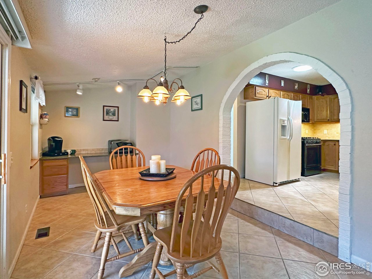 807 Locust Street Windsor, CO 80550 - Photo 11 of 40 a view of a dining room with furniture and chandelier