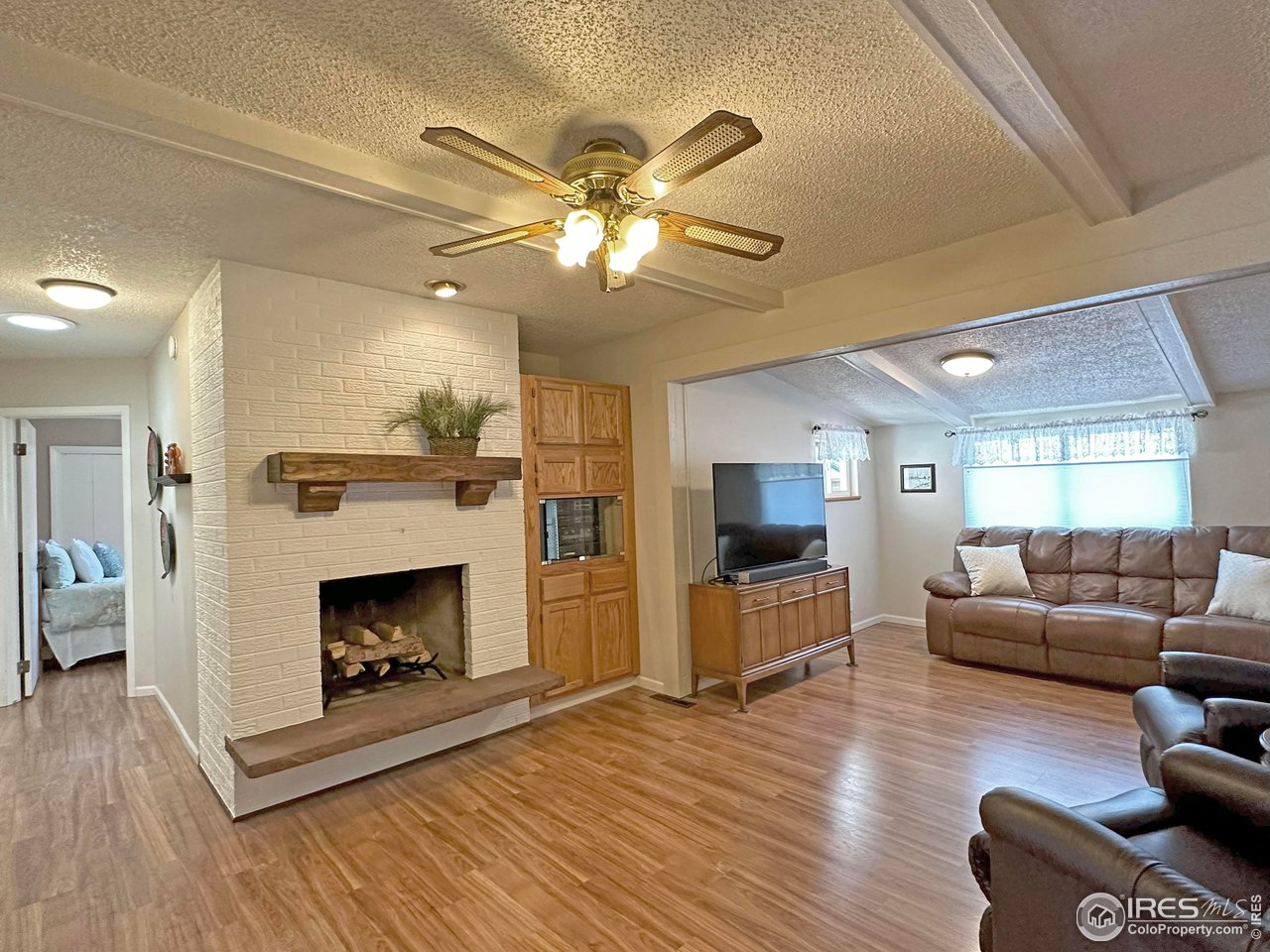 807 Locust Street Windsor, CO 80550 - Photo 13 of 40 a living room with furniture and a fireplace