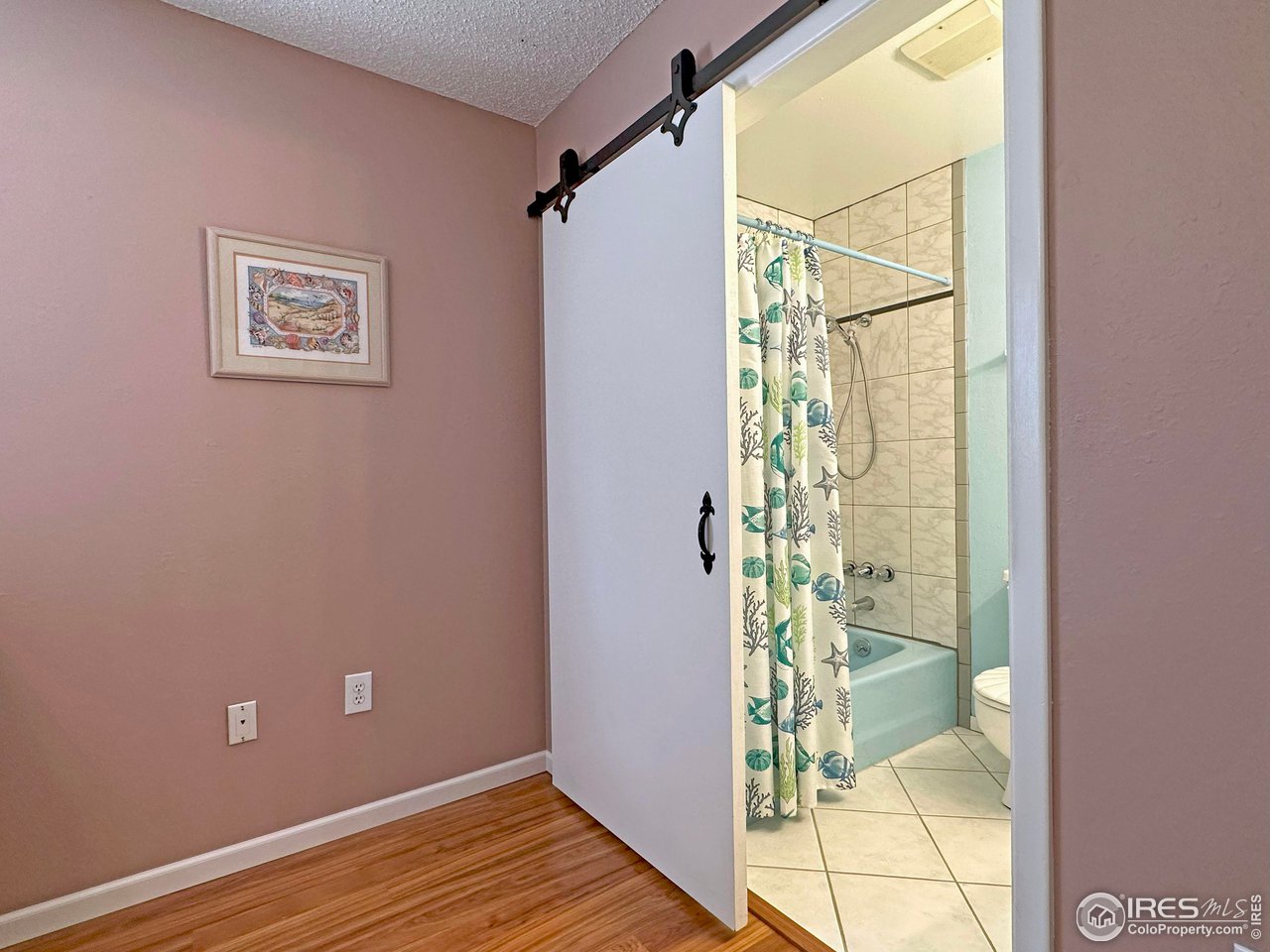 807 Locust Street Windsor, CO 80550 - Photo 17 of 40 a view of a bathroom with a shower and a window