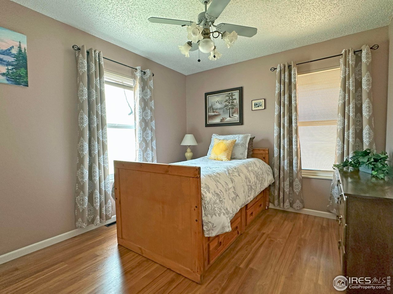 807 Locust Street Windsor, CO 80550 - Photo 19 of 40 a bedroom with bed and wooden floor
