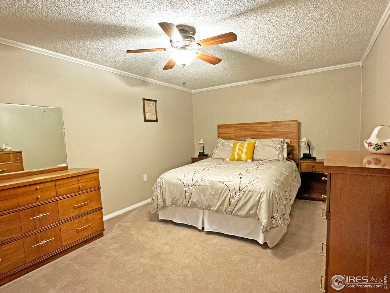 807 Locust Street Windsor, CO 80550 - Photo 26 of 40 a bedroom with a bed and cabinets